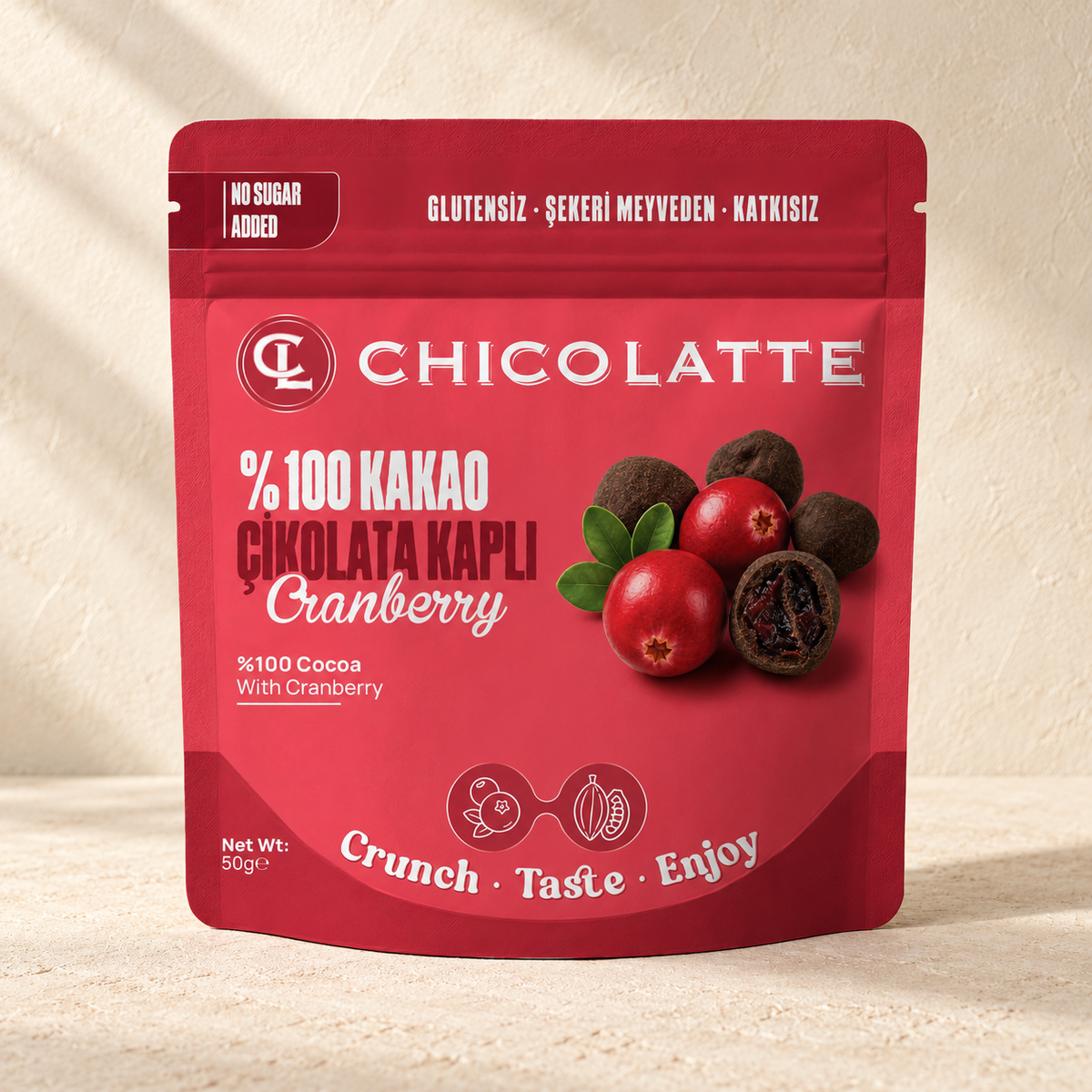 CHICOLATTE Bitter Çikolata Kaplı Cranberry 50 g, sıcak krem zeminde ambalaj fotoğrafı